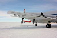 A MCoRDS’s underwing radar antenna arrays mounted beneath the wing of NASA’s P-3 aircraft at McMurdo Station’s airfield