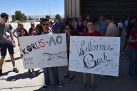 Kyle Kabasares (left), physics major at University of California Merced, and Mariah Heck (right), geophysics and geology major at University of Tulsa hold signs to welcome home the DC-8 crew home from the Korean U.S. Air Quality mission. Credits: NSERC Photo / Jane Peterson