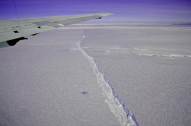 A photo from the window of NASA's DC-8 shows the rift across the Pine Island Glacier ice shelf running off toward the horizon. The plane flew across the crevasse on Oct. 26, 2011 as part of NASA's Operation IceBridge, and also flew directly over the rift for about 18 miles, taking detailed measurements of its depth, width and shape. The ice shelf hadn't calved a major iceberg since 2001, and IceBridge took advantage of the opportunity afforded by spotting the crack to fly over it and measure its characteris