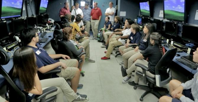 Students and teachers from Guam High School learn about how ATTREX scientists control their instruments on Global Hawk from the Payload Mobile Operations Facility. 