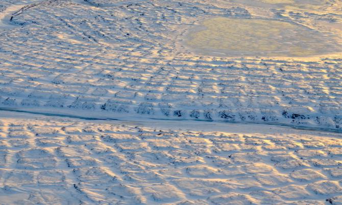 Winter sun setting over the tundra polygons in northern Alaska in November 2015. As winter sets in and snow settles, the soils take time to freeze completely and continue to emit carbon dioxide long into the new year. Credits: NASA/JPL-Caltech/Charles Miller
