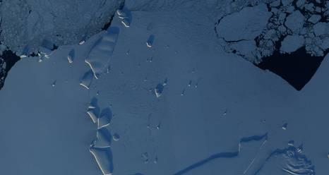 East Antarctic coastline. Icebergs are highlighted by the sunlight, and the open ocean appears black. Image Credit:  NASA