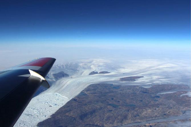 Helheim Glacier, with its characteristic wishbone-shaped channels, as seen from about 20,000 feet in the sky. Credits: NASA/Operation IceBridge