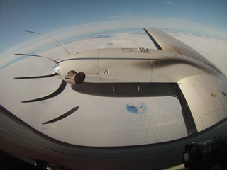 The ICESat-2 mission flew a laser altimeter instrument aboard an aircraft over Greenland in August 2015, to determine how green laser light interacts with different types of snow and ice. (The peculiar appearance of the plane's propeller is an artifact of the way the digital camera records pixels, not all at once when an image is taken.) Credits: NASA/Mike Wusk