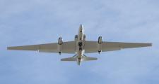 With full flaps and speed brakes deployed, one of NASA's high-altitude ER-2 environmental science aircraft descends on final approach to the runway at Air Force Plant 42 in Palmdale, Calif. The research aircraft is based at NASA Armstrong's Bldg. 703 adjacent to the Air Force facility.