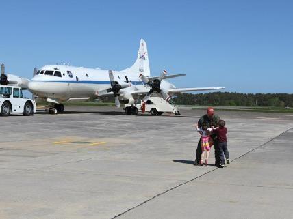 NASA Wallops Aircraft Office flight engineer Brian Yates meets his children after the P-3B returned from Operation IceBridge’s Arctic campaign.