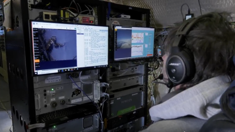 A research scientist monitors data measurements in-flight during the spring campaign of the ARCSIX mission. NASA/Gary Banziger