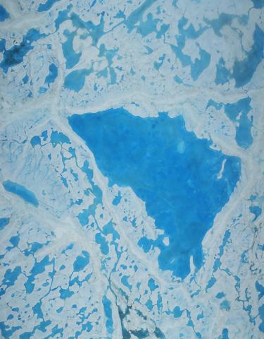 A large pool of melt water over sea ice, as seen from an Operation IceBridge flight over the Beaufort Sea on July 14, 2016. During this summer campaign, IceBridge will map the extent, frequency and depth of melt ponds like these to help scientists forecast the Arctic sea ice yearly minimum extent in September. Credits: NASA/Operation IceBridge