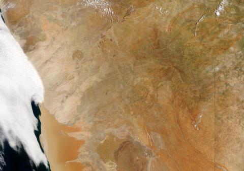 The Namibian coast of southwest Africa (far left) is a unique natural laboratory with both persistent low-level clouds and a steady supply of tiny aerosol particles in the form of smoke from inland fires that mix with the clouds. Credits: NASA