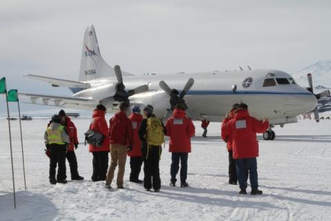 Members of the IceBridge team greet the NASA P-3 after its first landing on McMurdo Station’s sea ice runway.